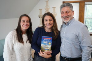 Sarah Burlew, Katie Stevenson & Merrick Rosenberg smiling together holding Merrick's book entitled, "Personality Wins, Who Will Take The White House and How We Know."
